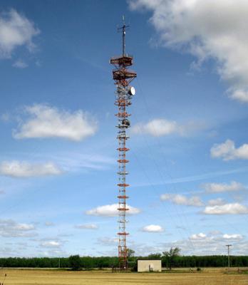 Older style tower being reused for a few microwave dishes and other unknown antennas up top. 